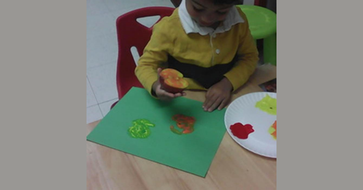 Toddler print making with apple